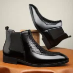 Bottines Chelsea en cuir noir avec empiècement effet python